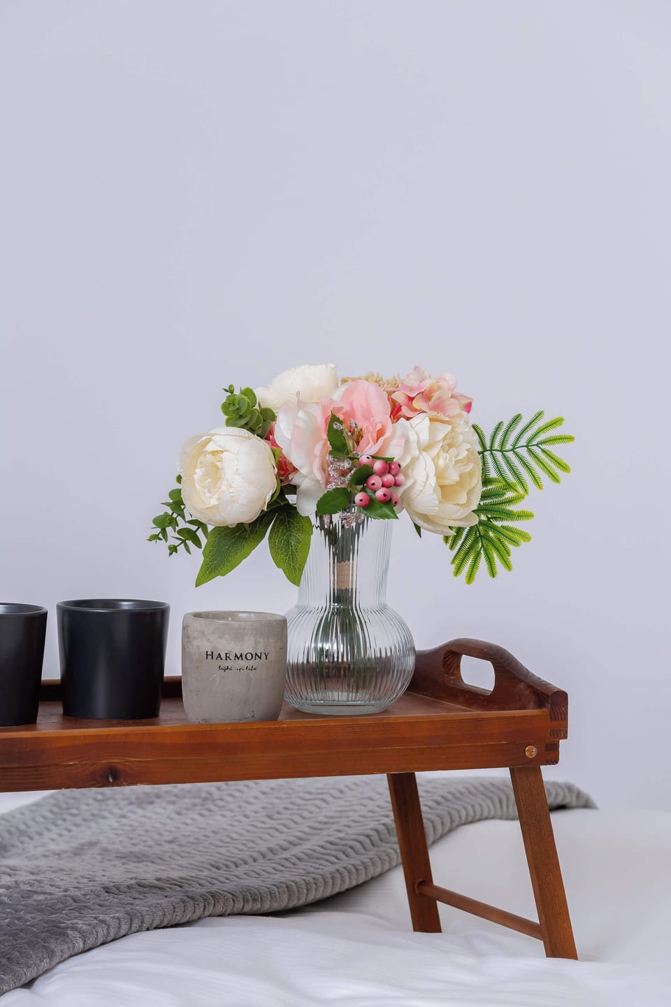 A flower arrangement and elegant accessories add a subtle charm to the space.