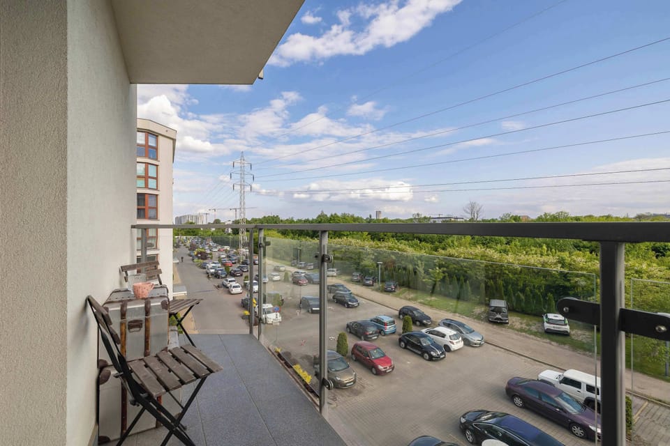 The balcony view over the open greenery offers a welcome break from the city bustle.