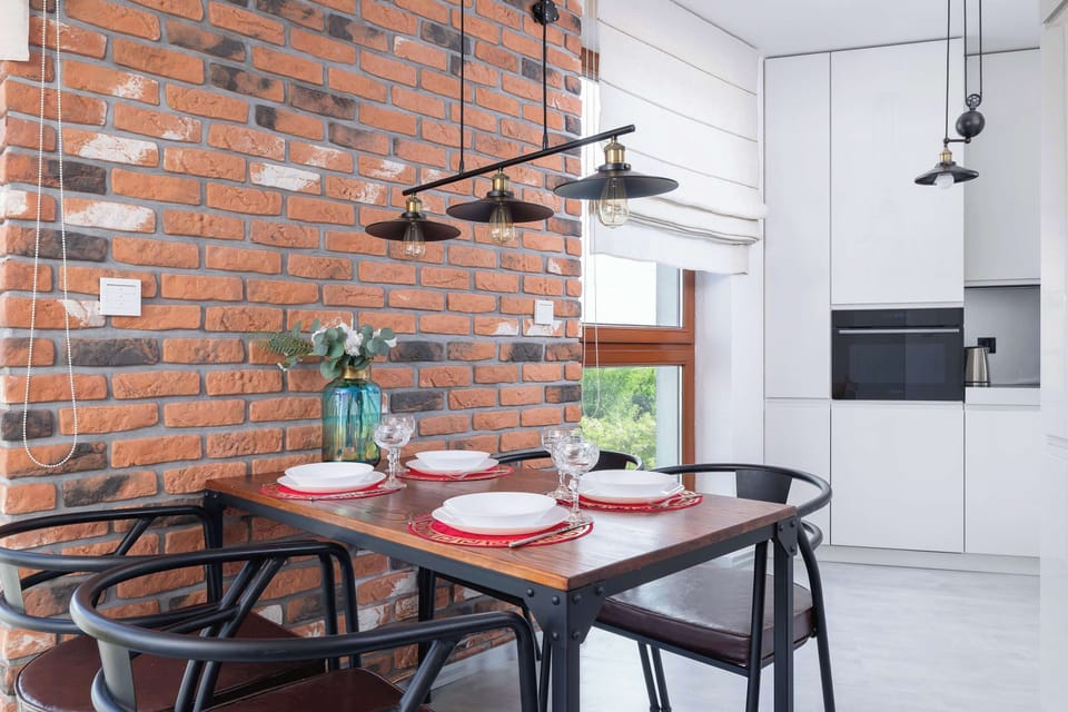 The dining nook with industrial lamps is a great spot for shared meals and conversations.