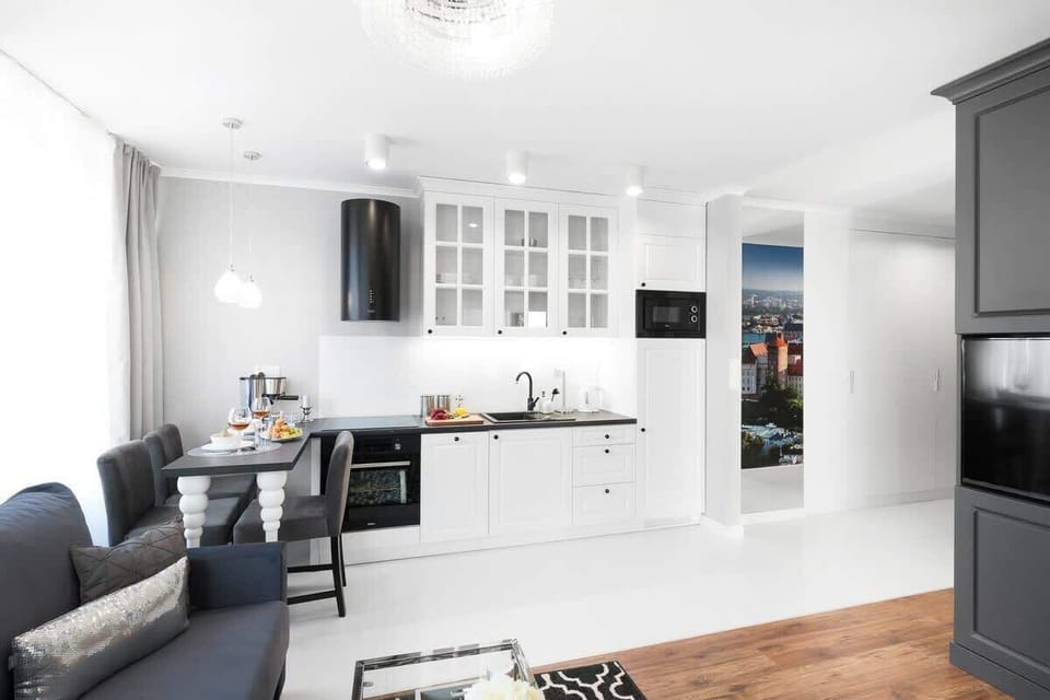 Bright and functional kitchenette with such appliances as an oven, a kettle and a microwave.