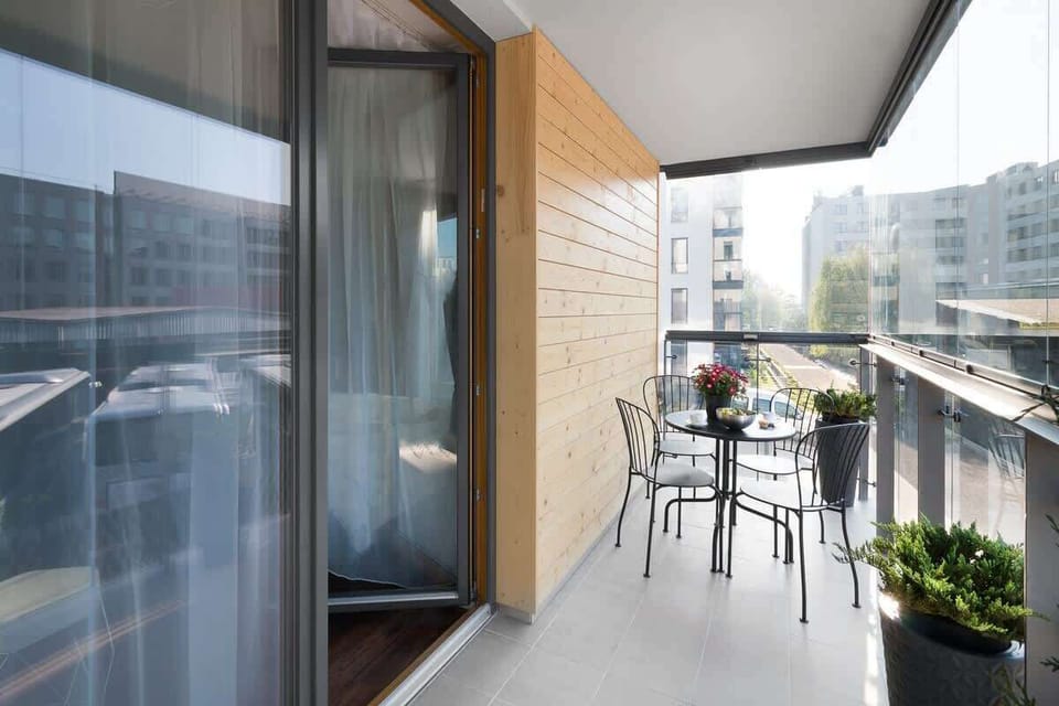 Comfortable balcony with garden furniture creating a cosy dining area, where the guests can enjoy their morning coffee or snacks.