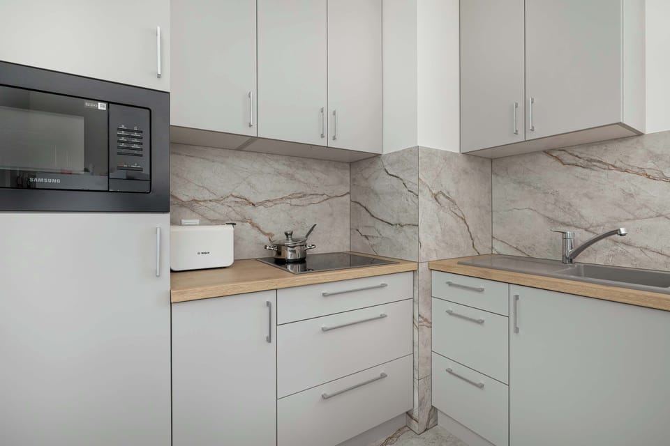 The kitchen has access to a number of appliances, including a dishwasher and a toaster.