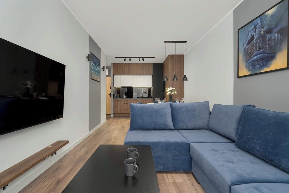 The spacious living room with a large, comfortable sofa and TV invites you to unwind after a long day.

