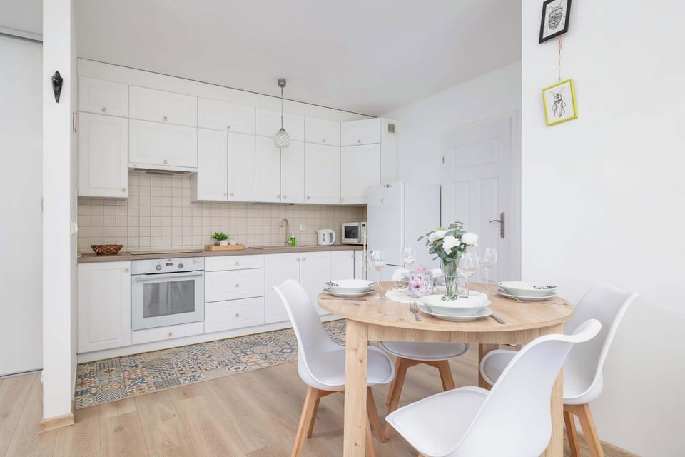 Fully equipped kitchenette and dining area with table and chairs.
