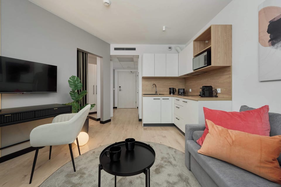 An open-plan living and dining area with comfortable seating and a minimalistic style.

