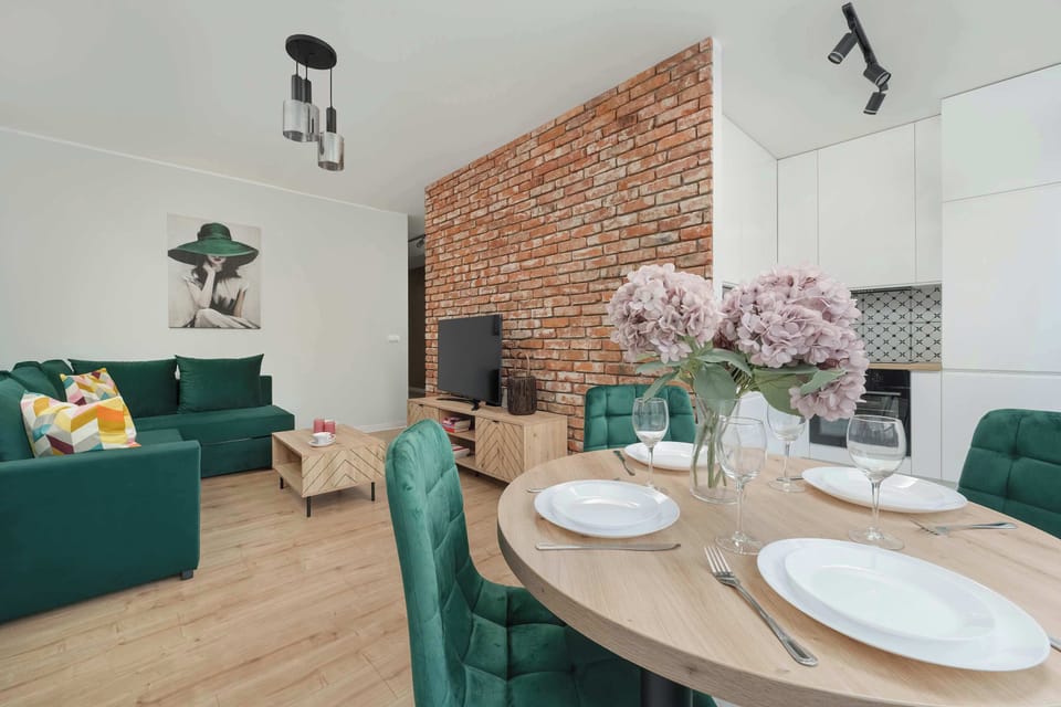 The cohesive combination of the dining area with the round-top table and the living room creates a space for relaxing and spending time with loved ones.
