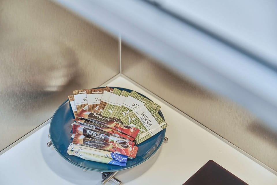 A close-up of a snack or breakfast setup, including coffee and packaged treats, showcasing hospitality.