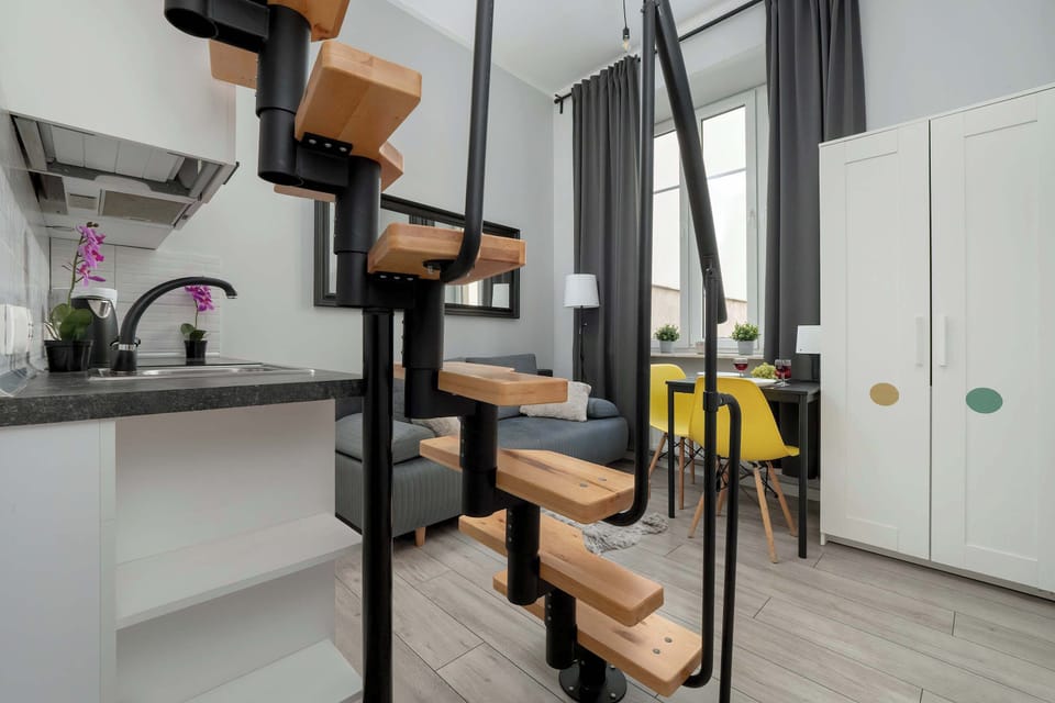 The living area has a large closet capable of holding many items. In addition, there are stairs leading to the mezzanine.