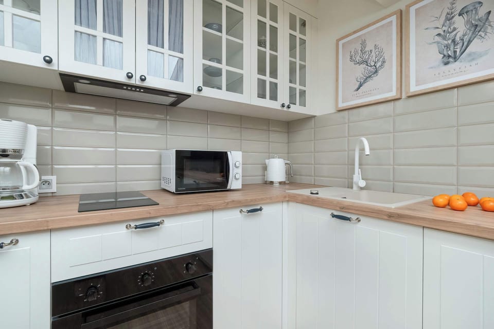 A full view of the kitchen area, combining appliances, cabinets, and ample workspace for cooking.