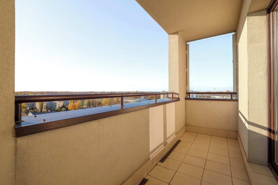 A sunny balcony overlooking the city, perfect for relaxing outdoors.