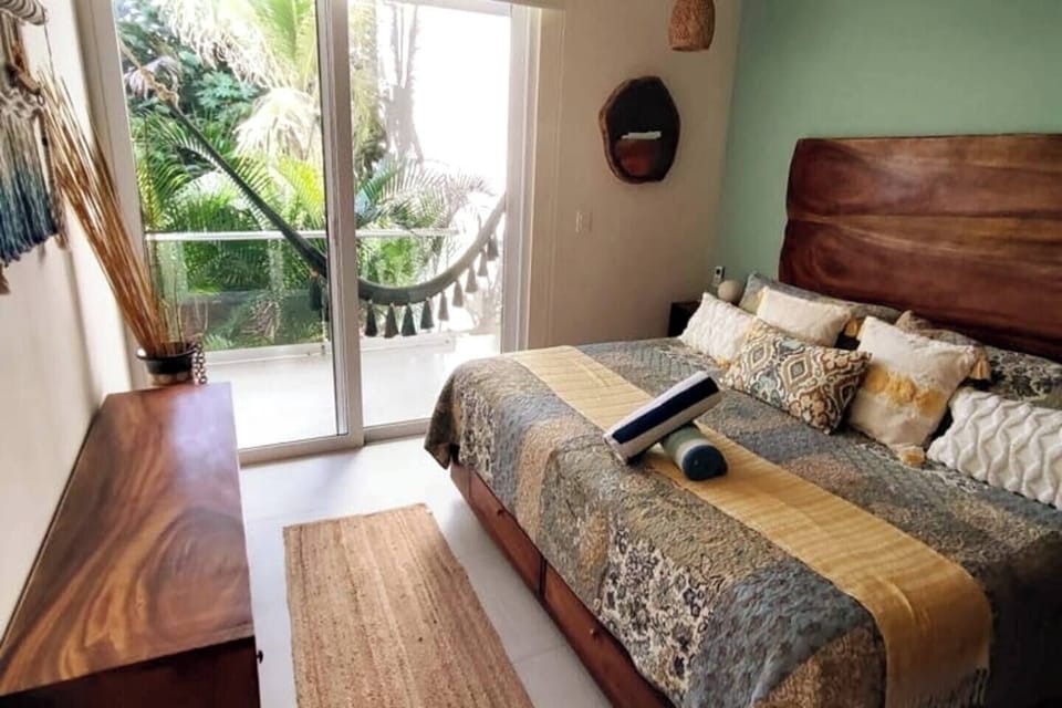Unwind in style: a room adorned with built-in closets and a luxurious king-size bed, offering a view of the lush jungle garden. Experience ultimate comfort amidst nature's embrace, where every detail is designed for your serene retreat.