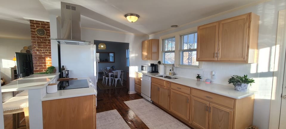 Full kitchen with plates, glasses, utensils & cookware 