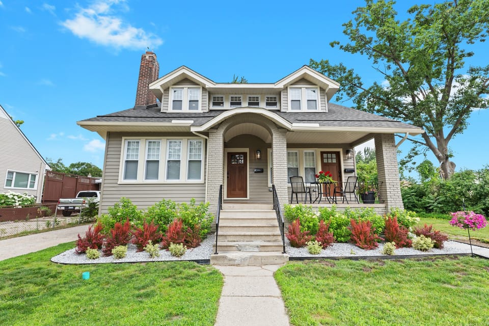 Charming craftsman-style home with inviting curb appeal and a beautifully landscaped front yard.