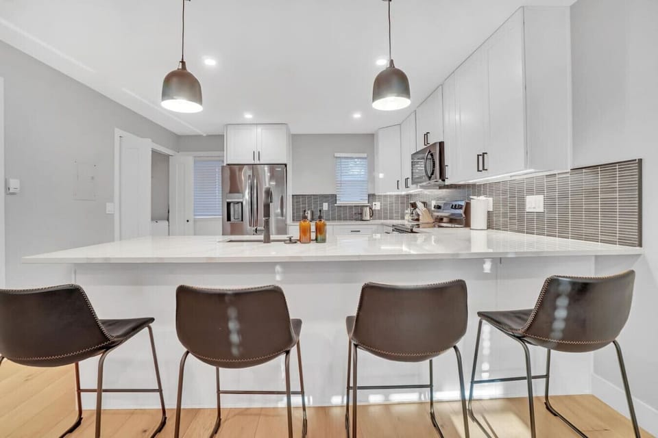 Beautifully updated and fully stocked kitchen with bar seating