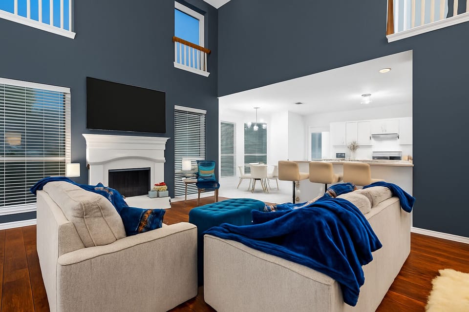 Gather in the stylish open-concept living room with fireplace, smart TV, and plush seating – ideal for downtime.