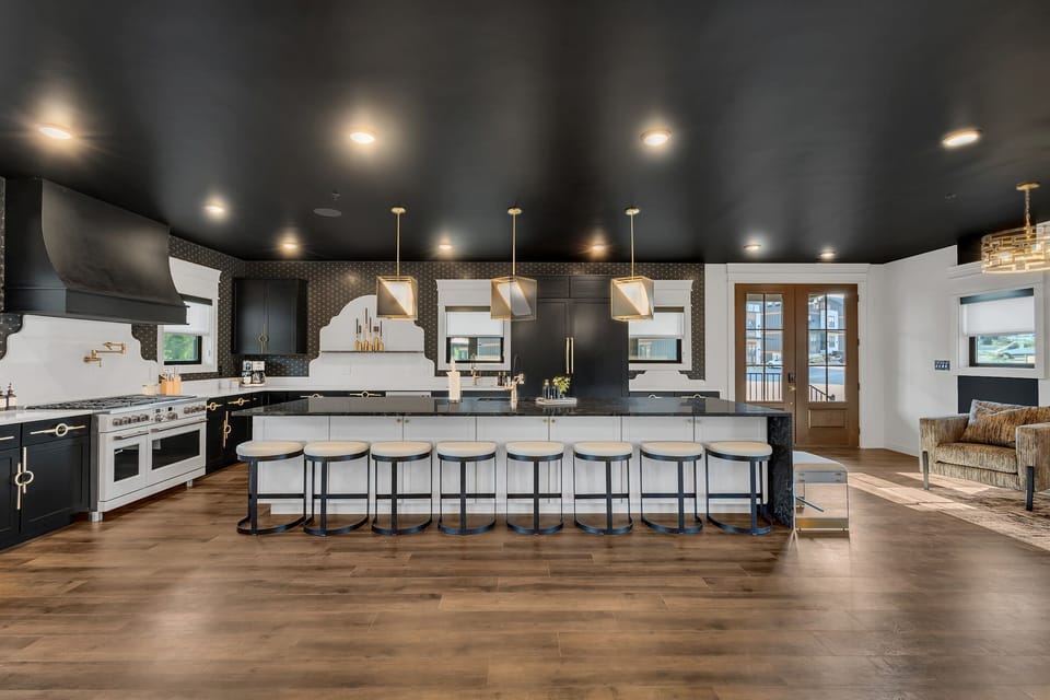 This fully equipped kitchen features high-end appliances and a large island perfect for cooking, serving, or gathering around for snacks and drinks.