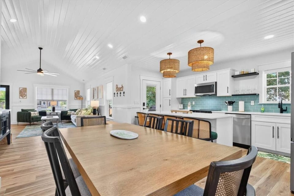This spacious dining table for up to six offers ample seating for shared meals and game nights, positioned seamlessly beside the beautifully updated kitchen.