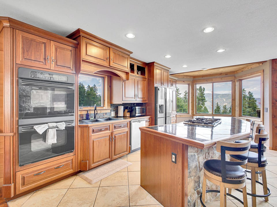 Fully stocked kitchen and dining space — perfect for family meals or chef-prepared dinners.
