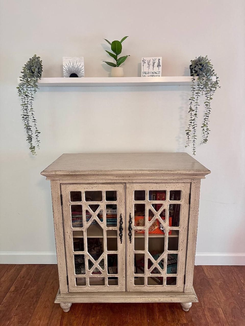 Family room cabinet with various books, games, and DVDs