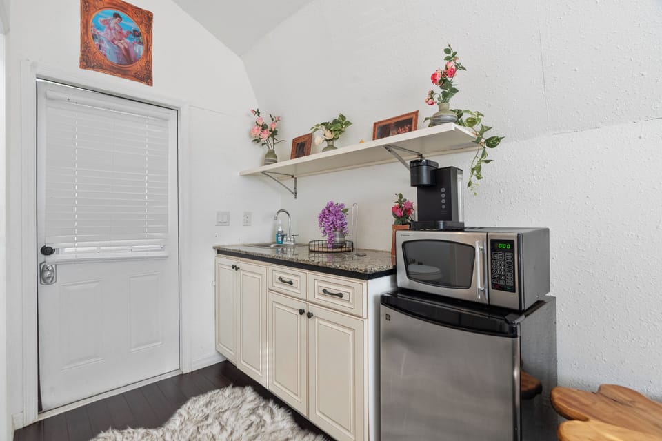 Compact kitchenette equipped with a mini fridge.