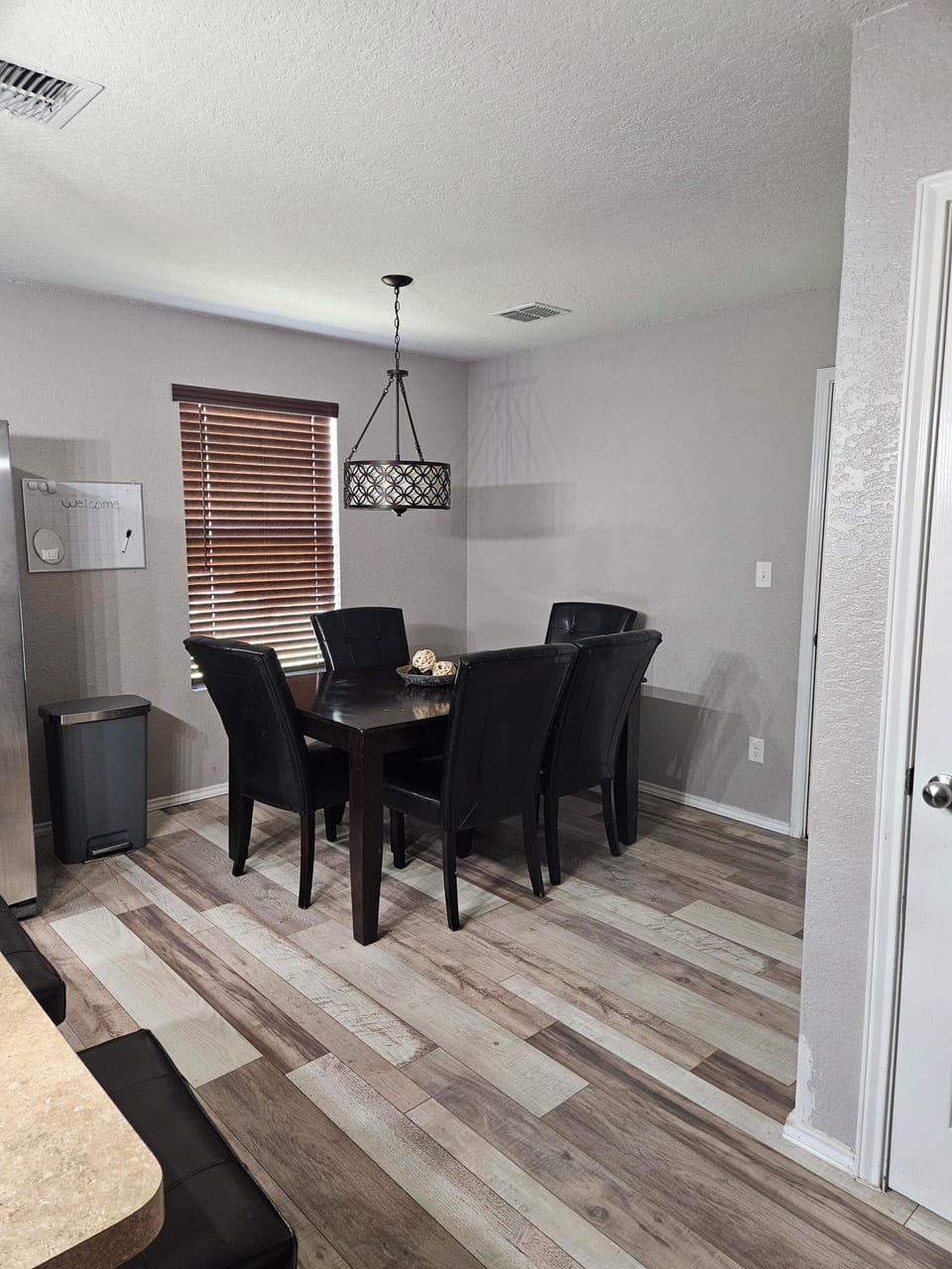 The dining area, next to the kitchen, seats 9 guests including bar stools.