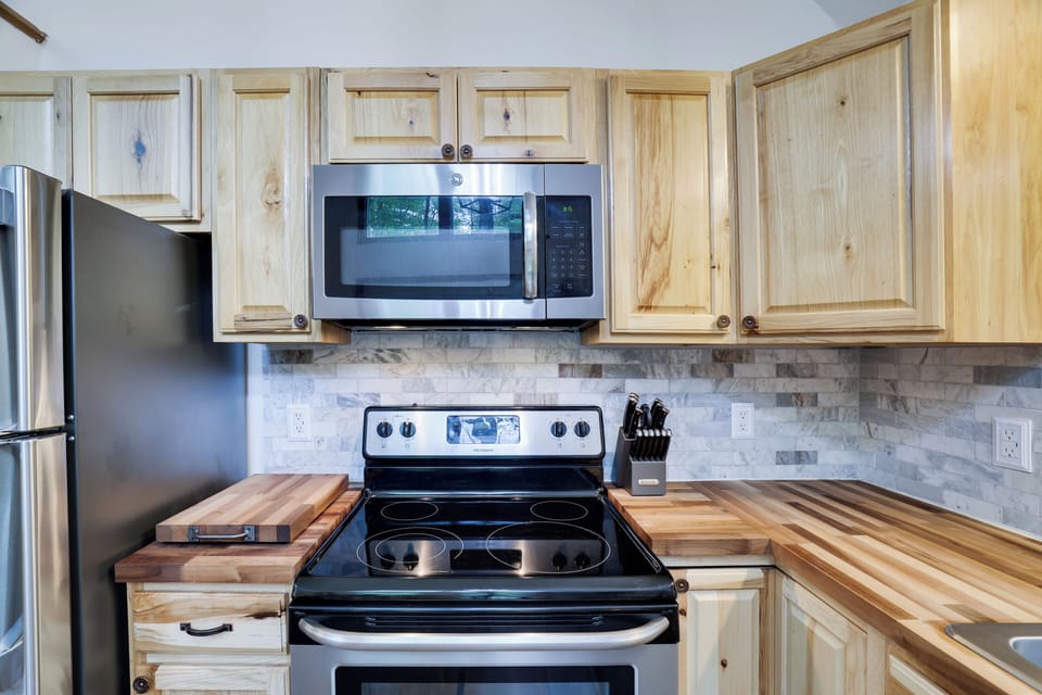 Full kitchen stocked with essential cookware.