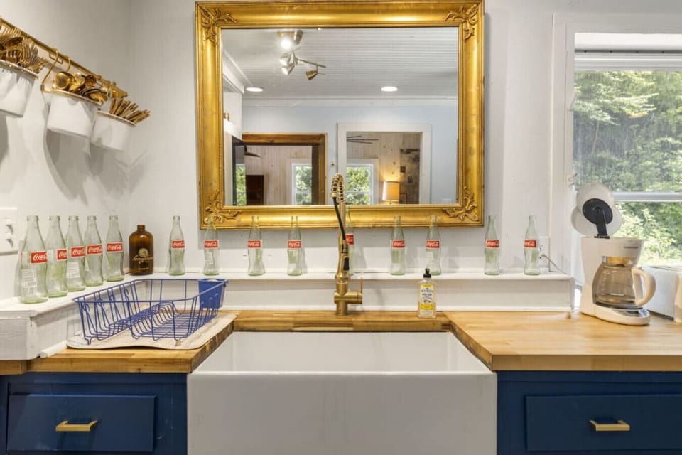 Kitchen includes large farmhouse sink.