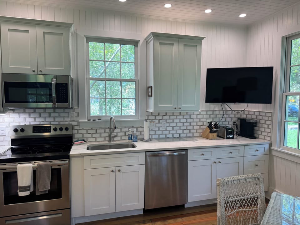 Fully stocked kitchen with all dishes, utensils, bakeware, and small appliances.