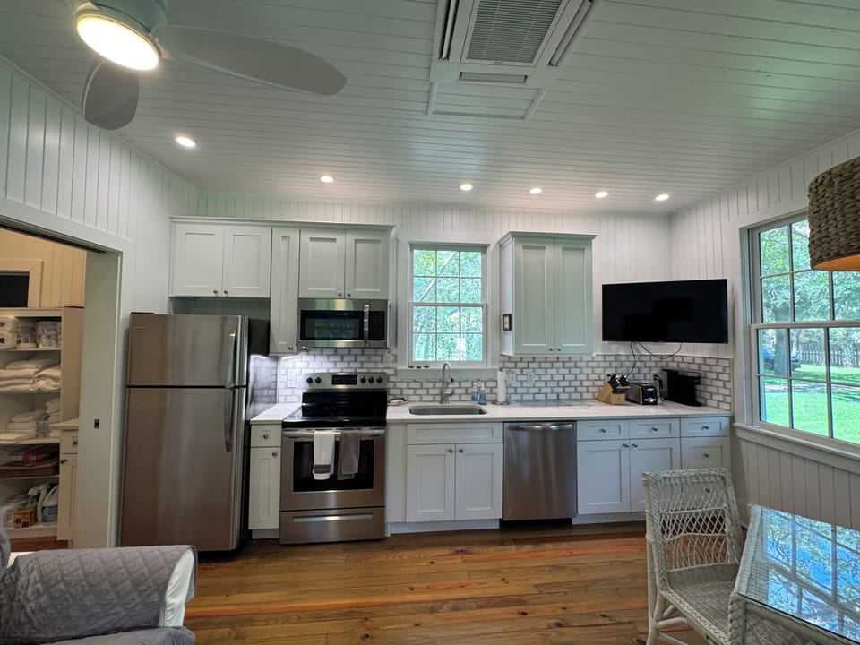 Fully stocked kitchen with all dishes, utensils, bakeware, and small appliances.