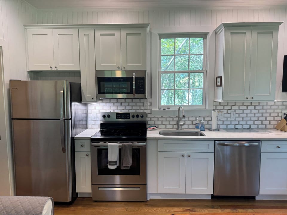 Fully stocked kitchen with all dishes, utensils, bakeware, and small appliances.