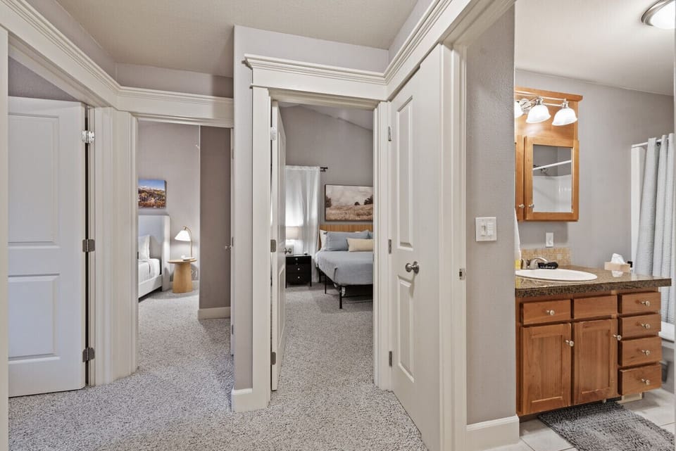 View from the central hallway of the guest bath, master bedroom, queen bedroom, and double-twin room