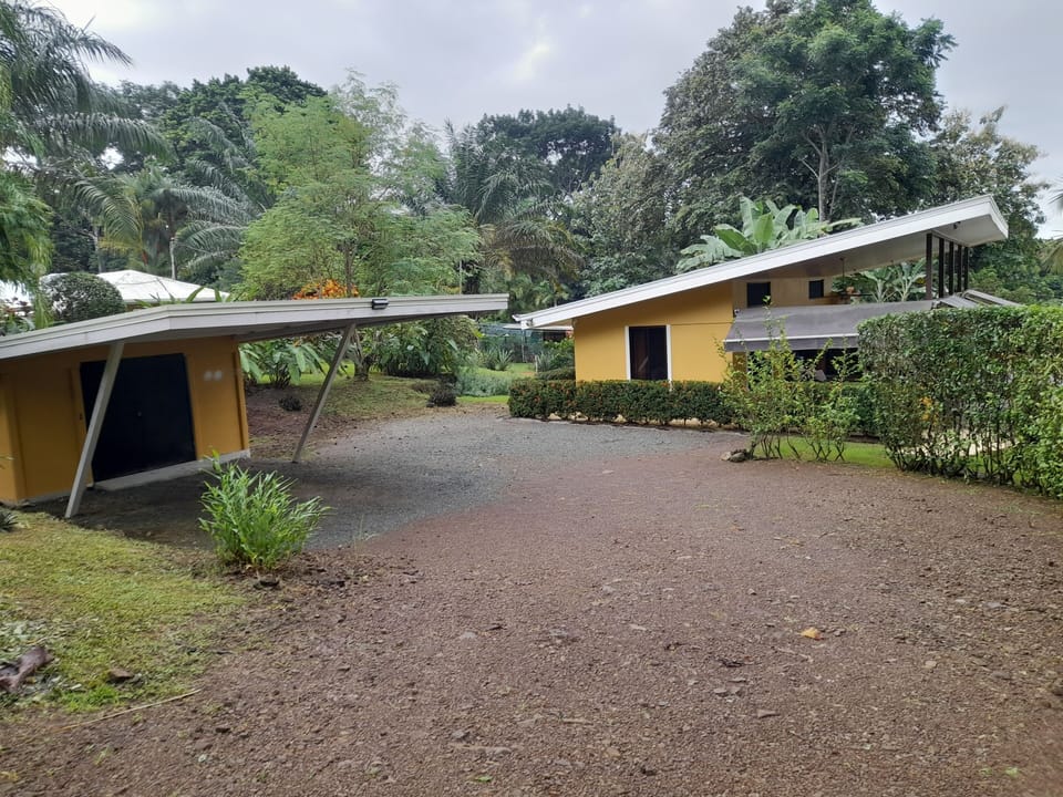 showing covered carport and storage bodega that has beach chairs, umbrellas, etc