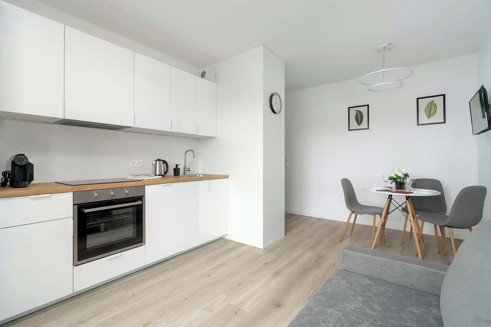 Kitchenette with oven and refrigerator. 