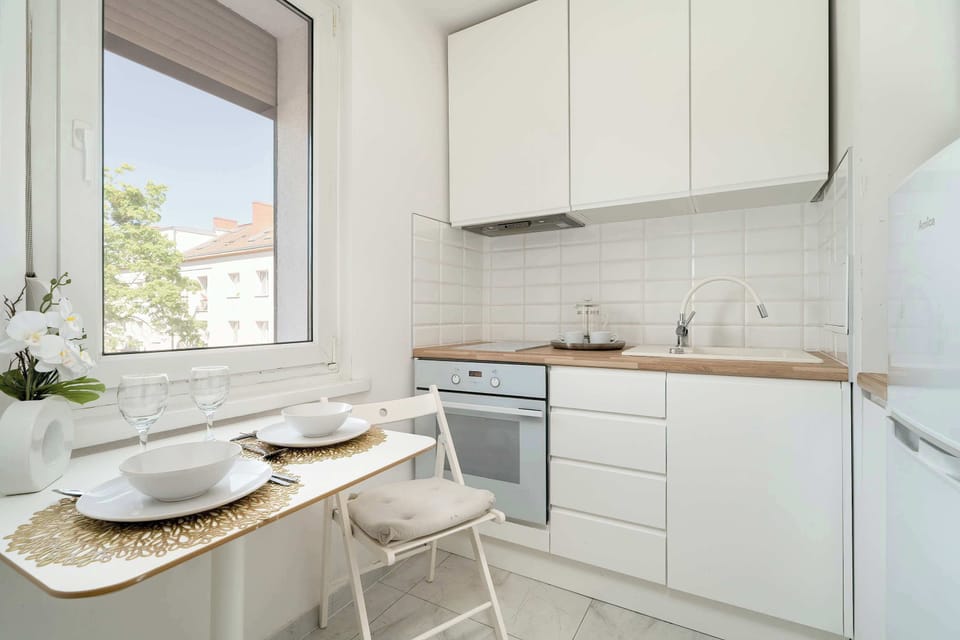 The spacious kitchen with a window overlooking greenery encourages peaceful cooking.