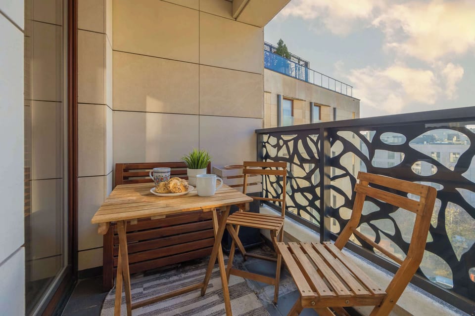 The balcony provides a tranquil spot for enjoying a book.