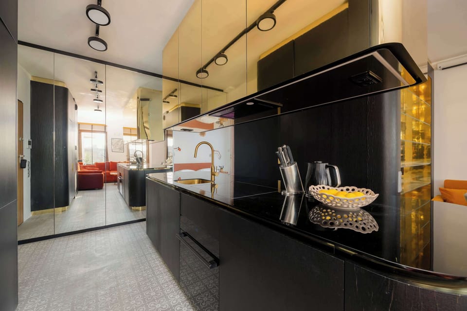 The sleek design of the kitchenette blending seamlessly with the living area.