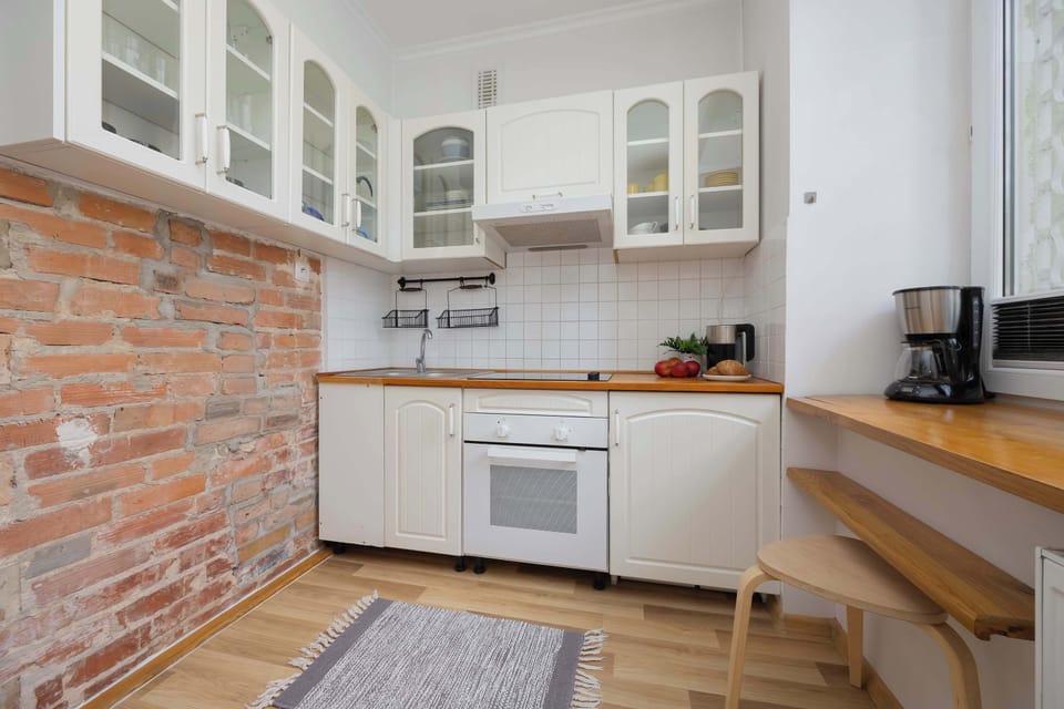 Fully equipped kitchen with electric hob, oven, microwave, refrigerator with freezer, electric kettle and coffee maker.