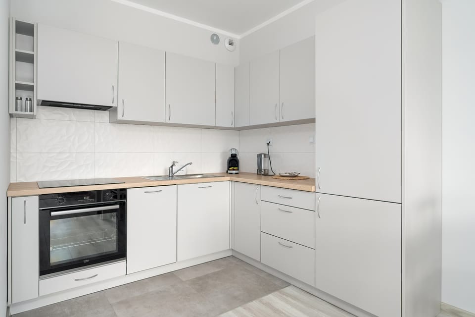 Functional kitchenette, where the guests can use such appliances as an oven, a kettle, and a dishwasher.