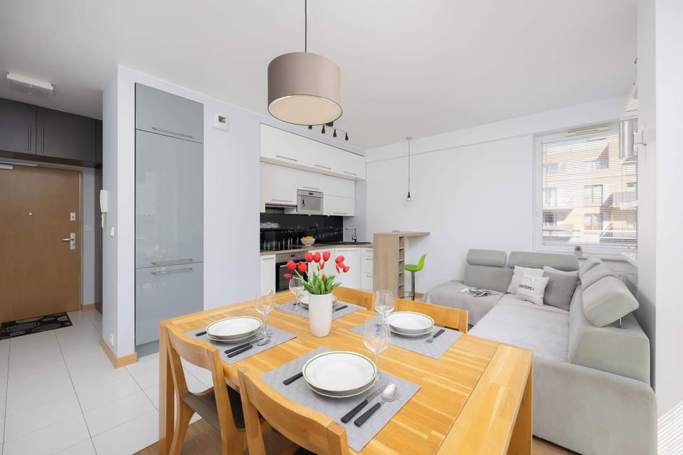 A small but functional dining space with a wooden table and chairs next to the kitchen.