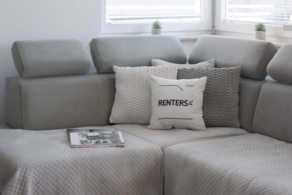 A close-up of the gray sofa with decorative pillows, creating a cozy and stylish ambiance.