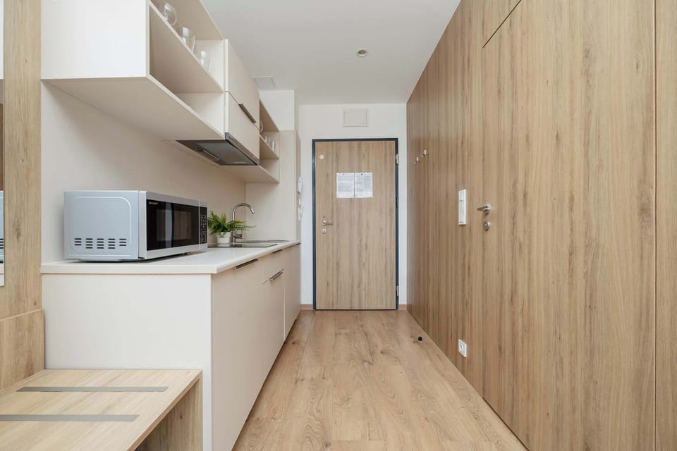A spacious hallway with wooden accents provides a warm and pleasant atmosphere from the very threshold.