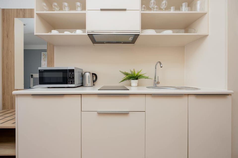 Functional kitchen cabinet with microwave and cooktop will be perfect for everyday cooking.