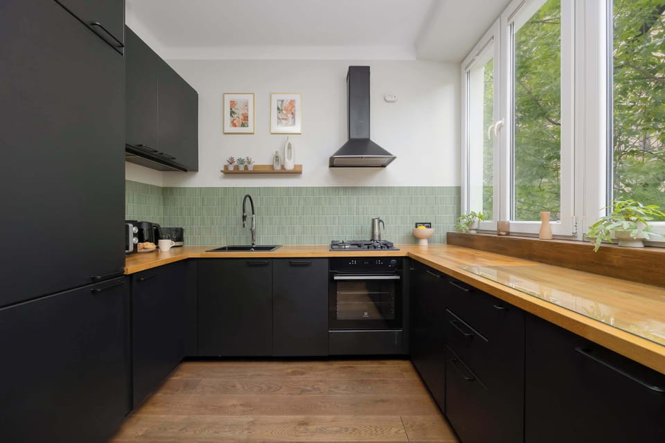 The sleek design of the kitchenette blending seamlessly with the living area.