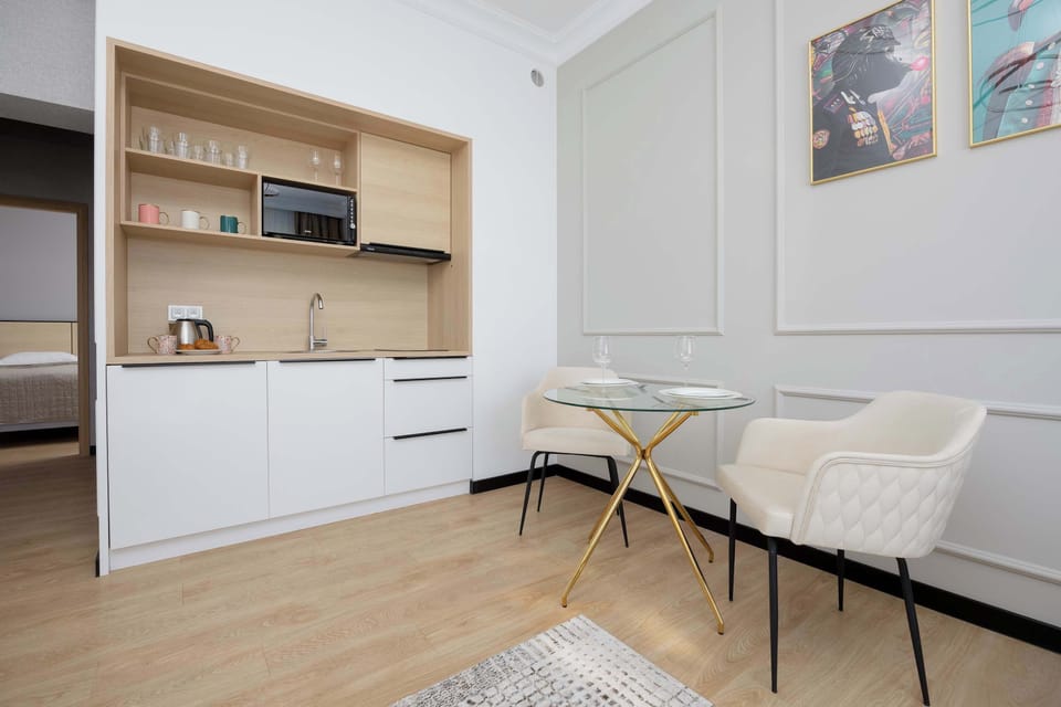 A view of the practical kitchenette and table and chairs ideal for dining.
