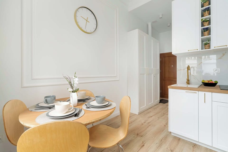 Fully equipped kitchenette with induction cooktop and dining area.