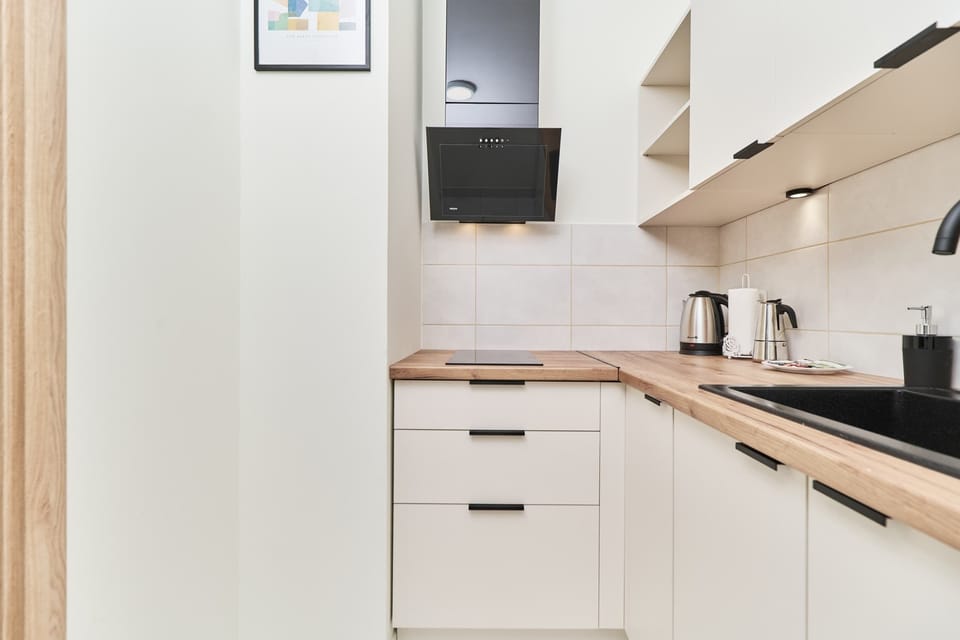 Kitchen featuring light-colored cabinets, modern appliances, and minimalist design for a clean look