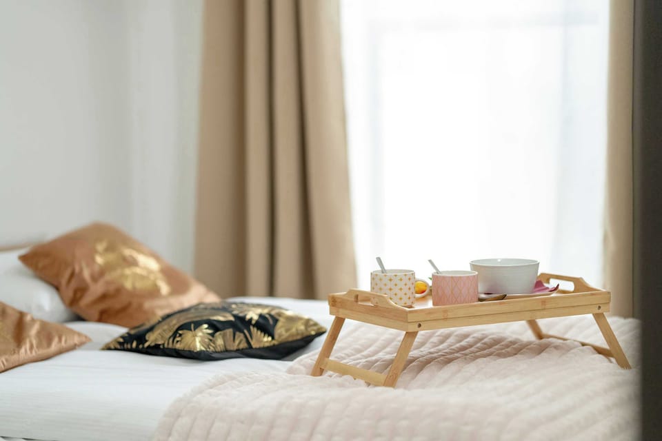 A bedroom with soft lighting, natural-colored bedding, and a welcoming atmosphere.