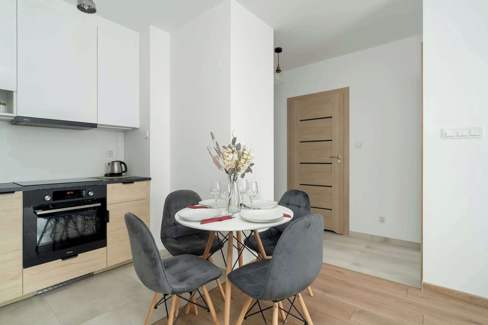 A section of the kitchen showing a black oven and countertop, featuring a clean, functional layout.
