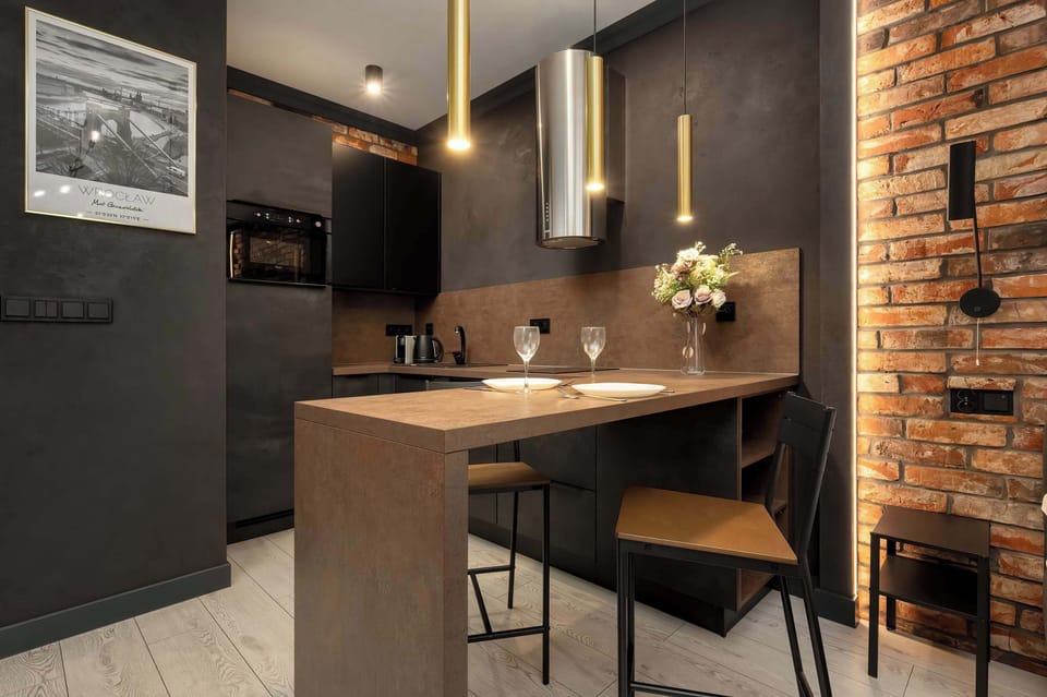 A compact kitchenette countertop with elegant lighting is ideal for a morning coffee or evening dinner.