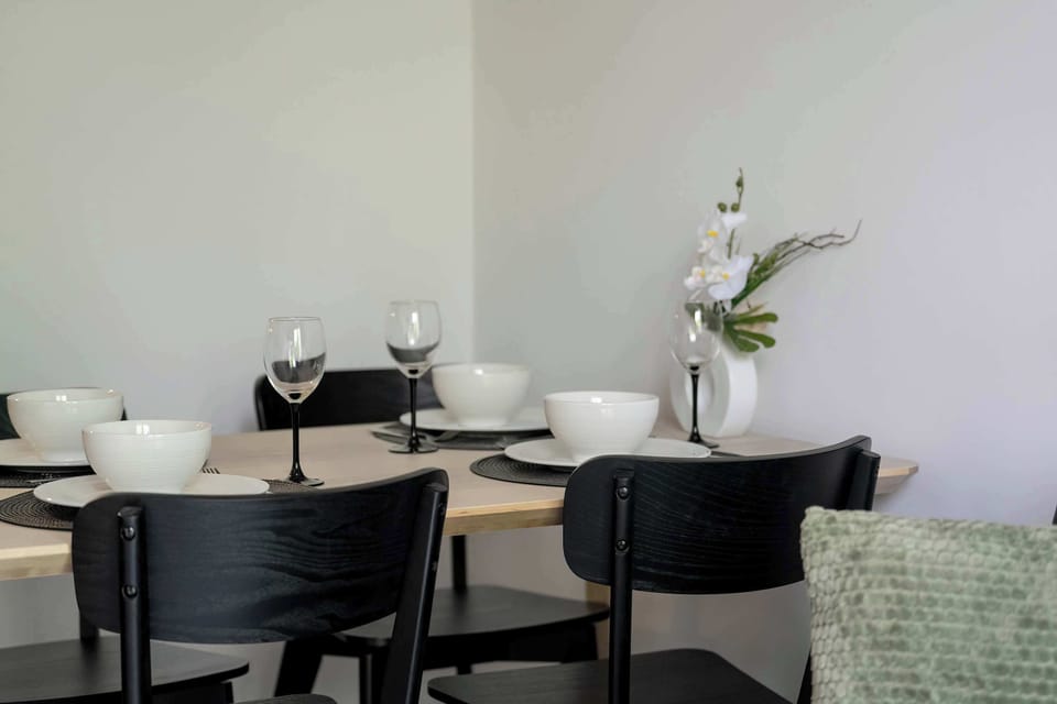 An elegant dining nook with a round table, four chairs, and a decorative vase adding charm to the interior.